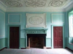 Detailed plaster work over the mantle picturing Aesop'd fable, "The Fox and Crow".